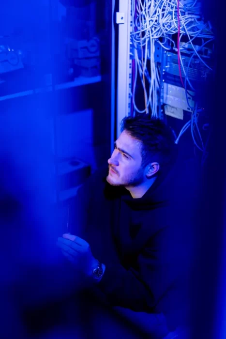 focused hacker in data center hacking software system vulnerable cyber security server